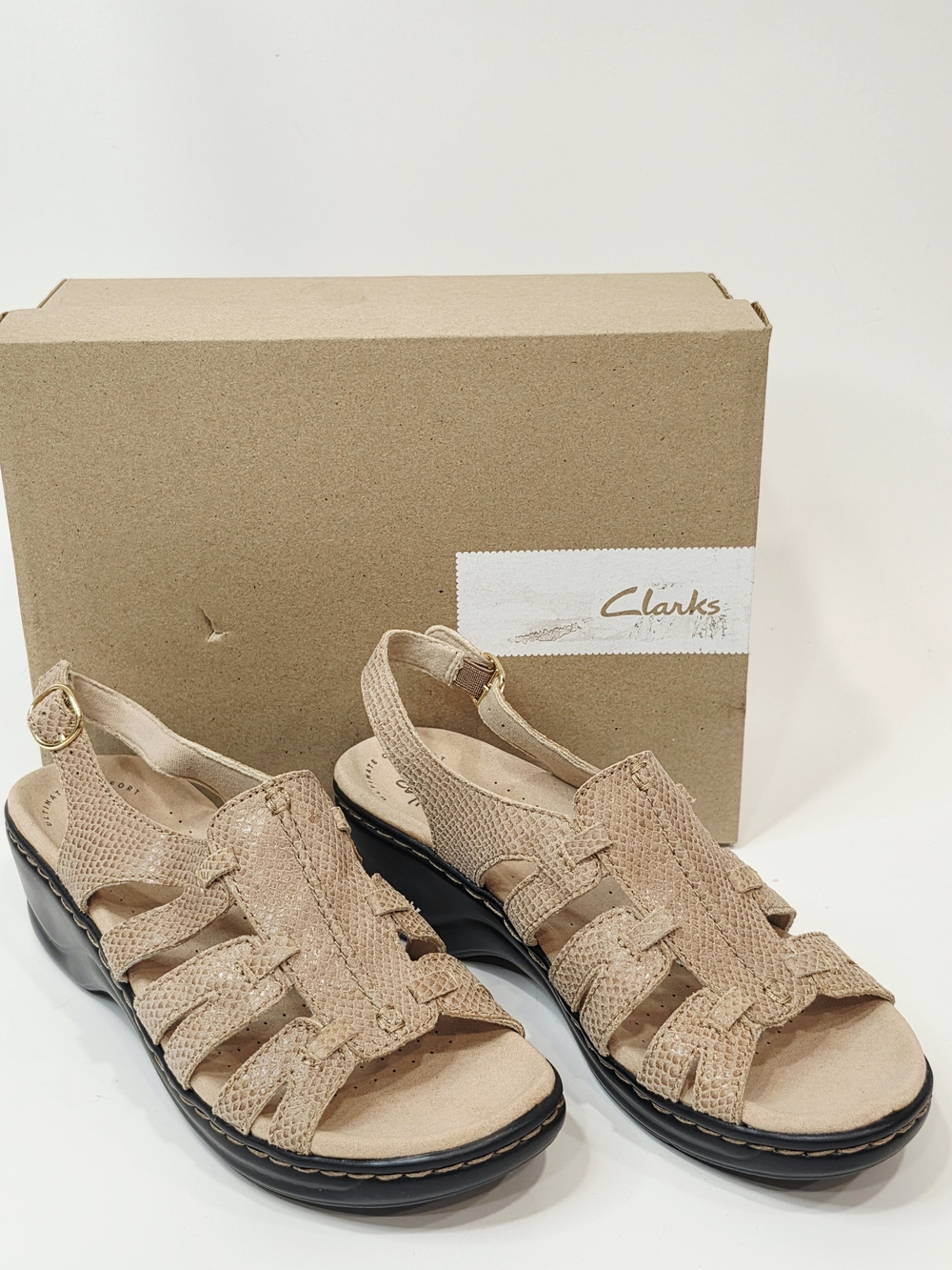 Clarks Lexi Marigold Q Sandals in a beige snake-print leather finish